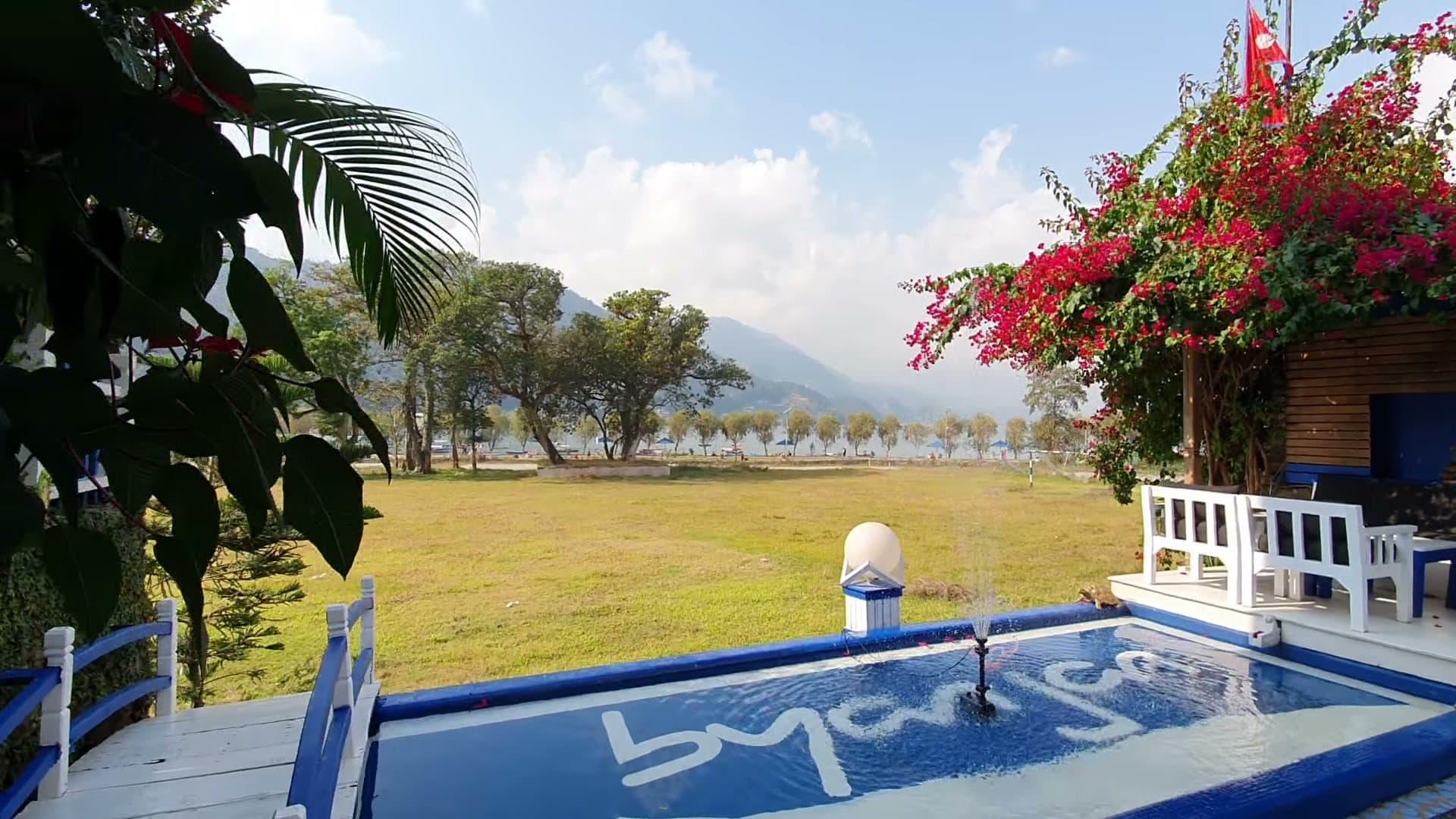 The pool with “byanjan” set in its tiles, under bougainvillea.